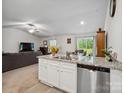 Open-concept kitchen with granite countertops, stainless dishwasher, and flows into the living area at 584 Lamorak Pl, Richburg, SC 29729