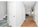 Bright hallway features hardwood floors, neutral walls, and access to the dining room and stairs at 5943 Pisgah Way, Charlotte, NC 28217