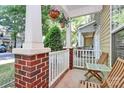Inviting front porch with brick pillars, white railings, and hanging flower baskets at 5943 Pisgah Way, Charlotte, NC 28217