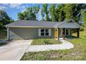 Charming single-story house with a welcoming walkway and yellow front door at 611 Fernwood Dr, Albemarle, NC 28001