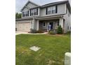 Charming two-story home with a two car garage, beautifully landscaped yard, and gray siding at 704 Robert Moses Dr # 121, Gastonia, NC 28056