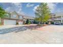 Charming complex featuring well-maintained exteriors, lush landscaping, and convenient parking, creating a welcoming atmosphere at 9047 Rosalyn Glen Rd, Cornelius, NC 28031