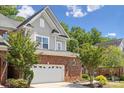 Exterior of two-story brick and gray home with attached garage and manicured landscaping at 907 Ospre Ln, Fort Mill, SC 29708