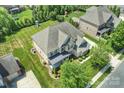 Aerial view of large home on landscaped lot with backyard playground at 9825 Ardrey Woods Dr, Charlotte, NC 28277