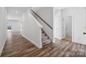 Inviting hallway featuring hardwood floors, carpeted stairs, and neutral decor at 1117 Hallman Branch Ln, Lincolnton, NC 28092