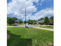 Spacious front yard with lush green grass, mature trees, and a view of the quiet neighborhood street at 1132 Preakness Nw Ct # 24, Concord, NC 28027