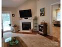 Comfortable living room featuring a fireplace, large windows, and access to the outdoor patio at 1132 Preakness Nw Ct # 24, Concord, NC 28027