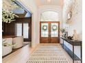 Elegant foyer featuring hardwood floors, stylish console table, and decorative mirror at 123 Archbell Point Ln, Mooresville, NC 28117