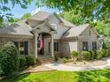 Charming, two-story brick home with an American flag hanging near the front door at 123 Archbell Point Ln, Mooresville, NC 28117