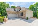 Side view of a brick house with a spacious three-car garage and ample driveway space at 123 Archbell Point Ln, Mooresville, NC 28117