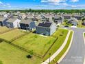 Aerial view showcases this home's large backyard and its proximity to other homes in the neighborhood at 133 W Neel Ranch Rd, Mooresville, NC 28115