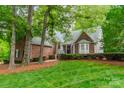 Charming brick home with a well-manicured lawn and mature trees in a peaceful setting at 134 Lawrence Tee Ln, Mooresville, NC 28117