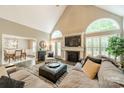 Bright living room with fireplace, cathedral ceiling, and large windows at 134 Lawrence Tee Ln, Mooresville, NC 28117