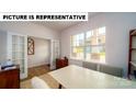 Bright office space featuring a large window, French doors, and neutral decor at 143 Way Cross Ln, Troutman, NC 28166