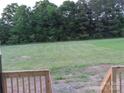 Expansive backyard view from wooden porch with mature trees surrounding the property at 144 Mason Tanner Ct, Rock Hill, SC 29730