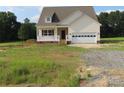 Charming home featuring light siding, a covered porch, and an attached garage with ample parking space at 144 Mason Tanner Ct, Rock Hill, SC 29730