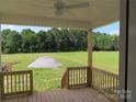 Covered porch featuring wood floors, wood railing, and a beautiful view of a lush green lawn and surrounding trees at 144 Mason Tanner Ct, Rock Hill, SC 29730