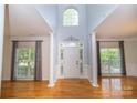 Bright and airy foyer with soaring ceilings, elegant columns, and hardwood flooring at 15406 Pepperwood Ct, Huntersville, NC 28078