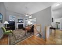 Spacious living area featuring a fireplace, hardwood floors, and seamless transitions to other rooms, ideal for gatherings at 160 Fernbrook Dr, Mooresville, NC 28117