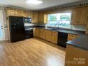 Well-lit kitchen featuring custom cabinets, modern appliances, and sleek countertops at 224 Locust Ave, Locust, NC 28097