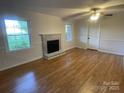 Bright living room with a beautiful fireplace and hardwood floors throughout at 224 Locust Ave, Locust, NC 28097