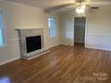 Bright living room with a beautiful fireplace and hardwood floors throughout at 224 Locust Ave, Locust, NC 28097