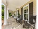 Inviting front porch with rocking chairs and elegant columns, offering a relaxing outdoor space at 2611 Forest Dr, Charlotte, NC 28211
