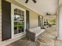 Covered front porch showcases a cozy seating area with neutral sofa and a ceiling fan at 2611 Forest Dr, Charlotte, NC 28211