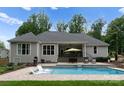Backyard boasts a covered patio and a pool with built in chairs for ultimate relaxation and enjoyment at 2646 Lee Lawing Rd, Lincolnton, NC 28092