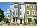 Beautiful townhome showcasing a blue exterior with large windows and a well-maintained front yard at 2907 W Trade St, Charlotte, NC 28208