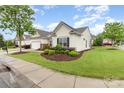 Beautifully landscaped home with a manicured lawn, complemented by a tidy sidewalk, creating curb appeal at 31470 Royal Tern Ln, Indian Land, SC 29707