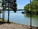 Picturesque view of the water with lush trees creating a sense of privacy at 4095 Kingfisher Dr, York, SC 29745
