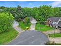 An aerial perspective showcases the home nestled on a cul-de-sac with mature trees, and a two-car garage at 5009 Ravens Ct, Matthews, NC 28104