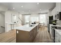 Stylish kitchen with a large center island, stainless steel appliances, and abundant natural light at 5030 Grain Orchard Rd # 3025C, Indian Trail, NC 28079