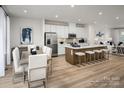 Open concept kitchen and dining area with hardwood floors, stainless steel appliances, and modern decor at 5030 Grain Orchard Rd # 3025C, Indian Trail, NC 28079
