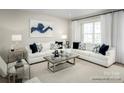Bright living room featuring two sofas, a modern coffee table, and large windows with white curtains at 5030 Grain Orchard Rd # 3025C, Indian Trail, NC 28079