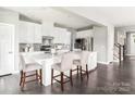 Spacious kitchen featuring a large island with bar seating, white cabinetry, and modern appliances at 522 Lenswood Ct, Denver, NC 28037