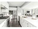 Bright, modern kitchen with stainless steel appliances, white cabinets, and a large island at 522 Lenswood Ct, Denver, NC 28037
