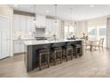 Bright, open kitchen features a large island with seating and stainless steel appliances at 521 Lenswood Ct, Denver, NC 28037