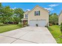 Two-story home with a large concrete driveway, two-car garage, and beautiful green shutters at 544 Cool Creek Dr, Rock Hill, SC 29732
