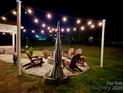 Inviting backyard with a cozy fire pit area, perfect for outdoor gatherings and relaxation under the stars at 6016 Willow Pin Ln, Huntersville, NC 28078