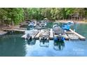 A well maintained dock on the lake, featuring multiple boat slips and covered lift at 7687 Bermuda Hills Ln, Denver, NC 28037