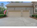 Three car garage, neutral colors, with well maintained driveway at 7687 Bermuda Hills Ln, Denver, NC 28037
