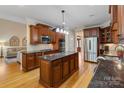 Gourmet kitchen with stainless steel appliances, a central island, and rich wood cabinetry at 7687 Bermuda Hills Ln, Denver, NC 28037