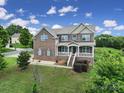 Lovely two-story brick home with a welcoming front porch and manicured landscaping at 9029 Woodview Ct, Fort Mill, SC 29707