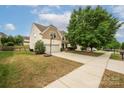 Two-story home featuring an attached two-car garage with basketball hoop and well-manicured lawn at 9159 Marasol Ln, Concord, NC 28027
