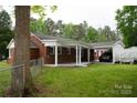 Exterior view of the covered carport attached to the brick home with a black vehicle at 925 Grace Ave, Lancaster, SC 29720