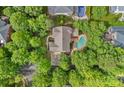 Aerial view showcasing a home with a pool nestled in a lush, green neighborhood at 9624 Barnburgh Ln, Huntersville, NC 28078