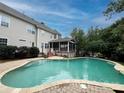 Backyard pool with a screened porch and composite deck at 9624 Barnburgh Ln, Huntersville, NC 28078