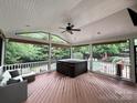 Spacious screened-in porch with wicker furnishings overlooking backyard pool at 9624 Barnburgh Ln, Huntersville, NC 28078